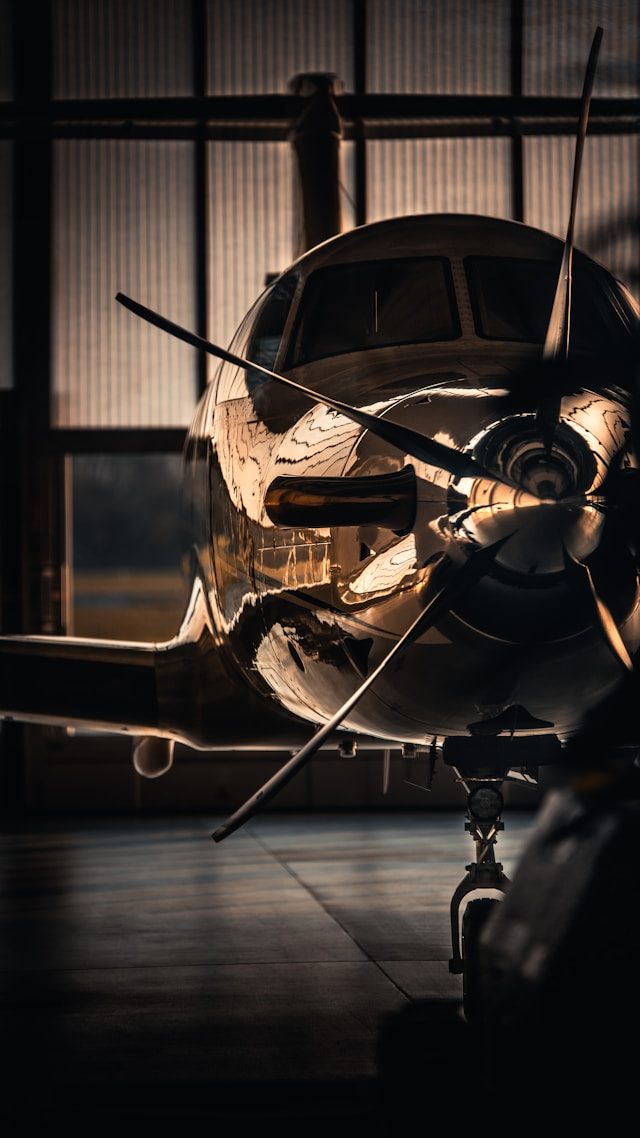 Private turboprop jet in a hangar at golden hour